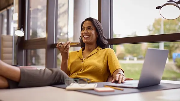 nonprofit woman with feet on desk relaxing